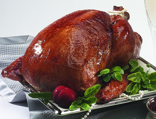 A turkey is sitting on top of a metal rack.