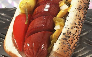 A hot dog with mustard, ketchup and relish.
