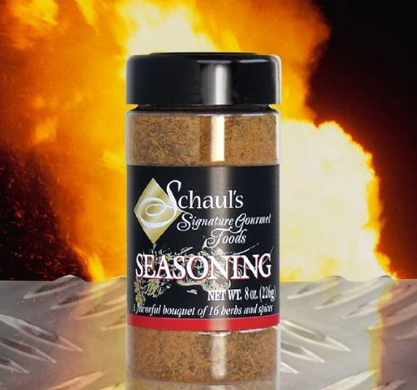 A jar of seasoning sitting on top of a table.
