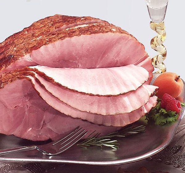 A ham sitting on top of a silver platter.